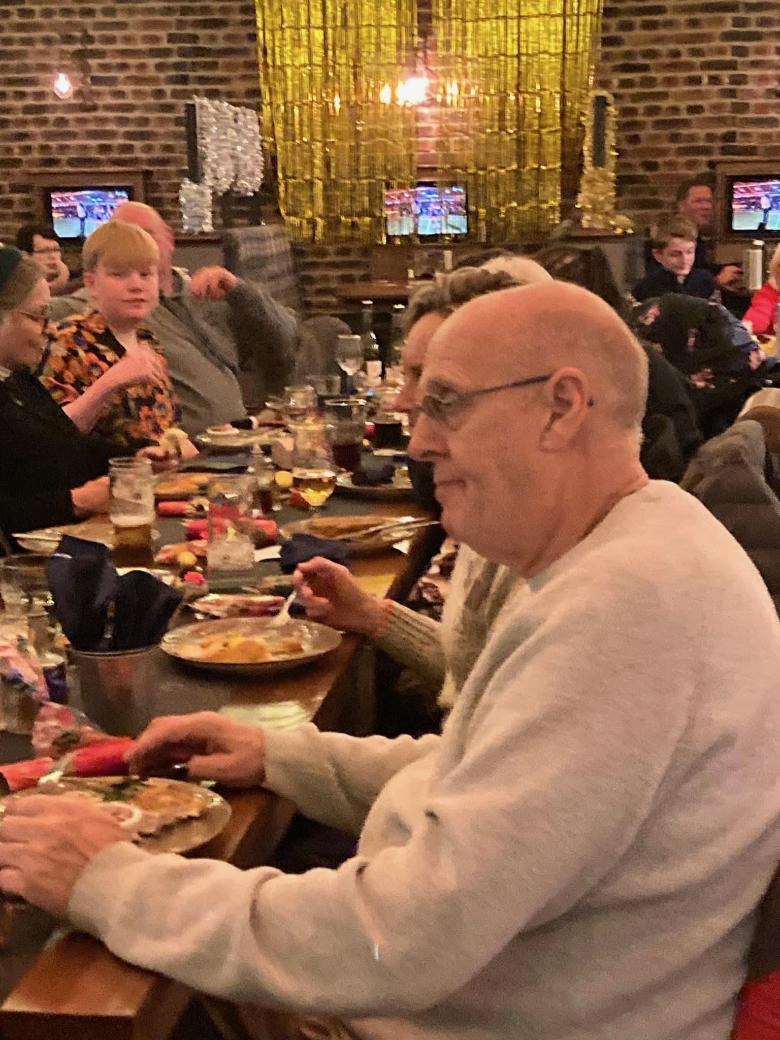 dog group meetup photo at table with over a dozen people